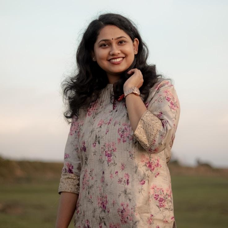 Kaveri Mehta, Lead Design Curator at Ivory Field Pro, reviewing corporate floral arrangements